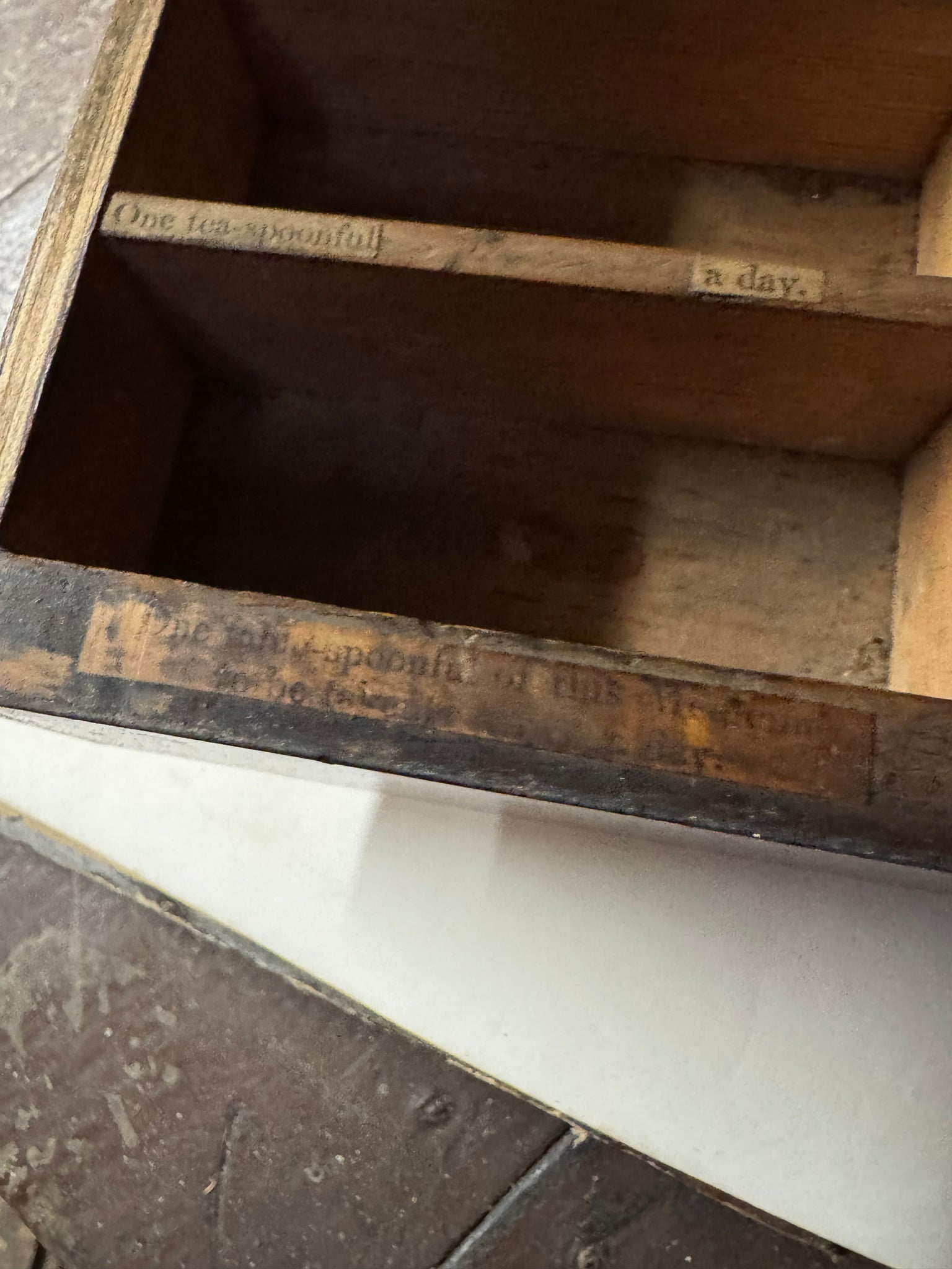 A 19th century set of mahogany apothecary wall shelves with original labels to drawer interiors