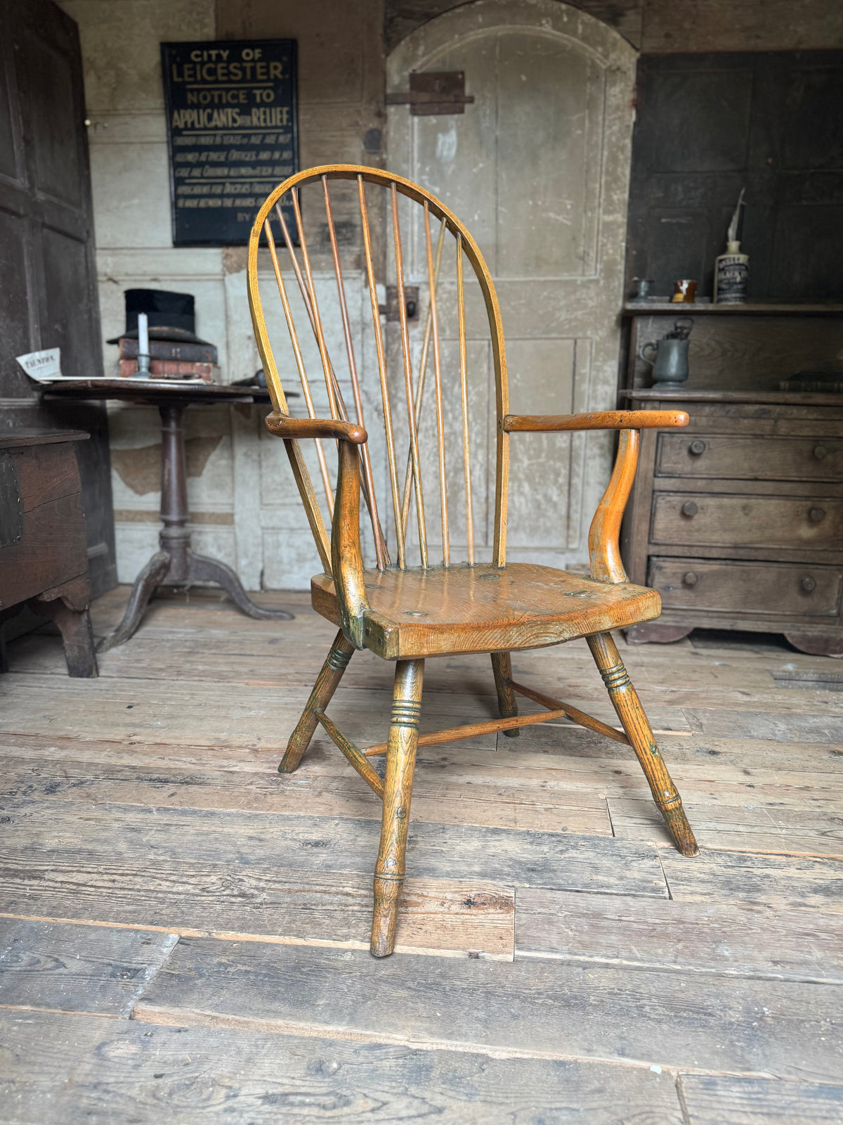 An unusual George III elm and ash high hoop-back Windsor armchair, probably West Country, circa 1800