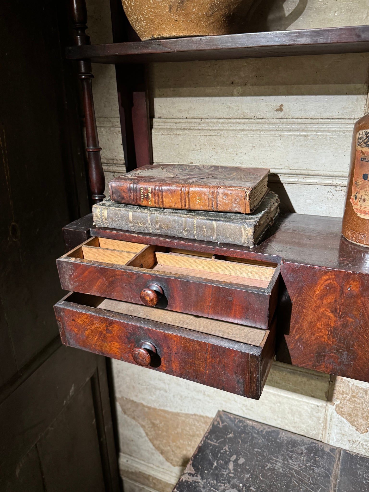 A 19th century set of mahogany apothecary wall shelves with original labels to drawer interiors