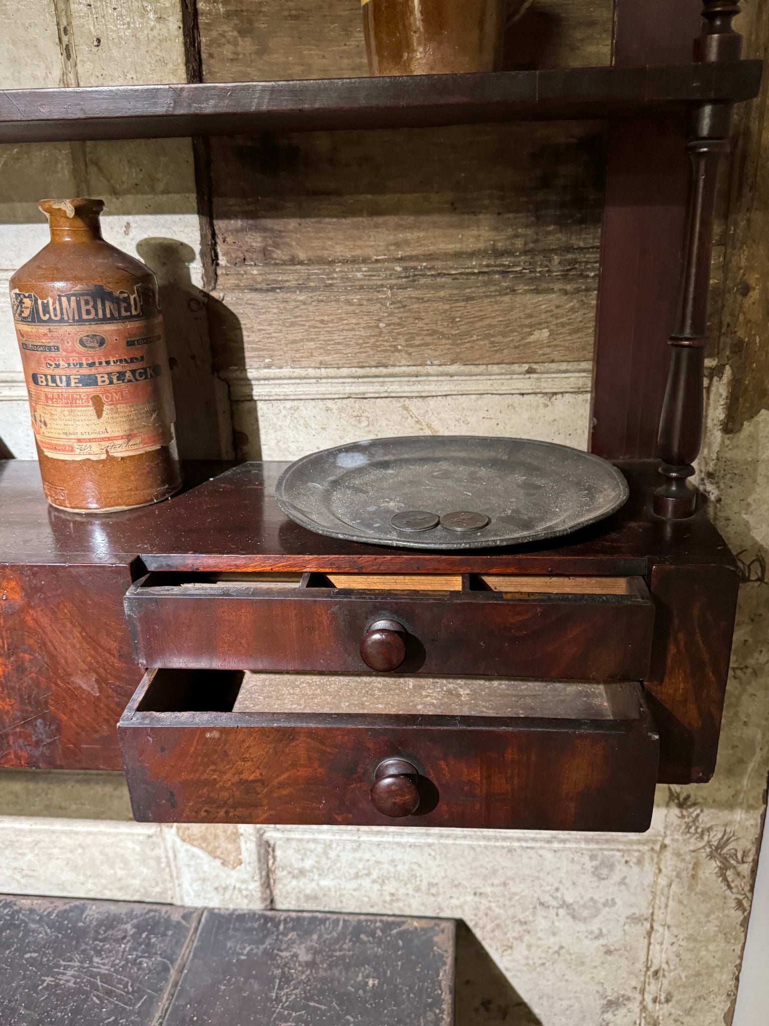 A 19th century set of mahogany apothecary wall shelves with original labels to drawer interiors