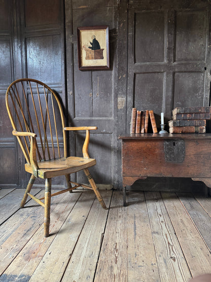An unusual George III elm and ash high hoop-back Windsor armchair, probably West Country, circa 1800
