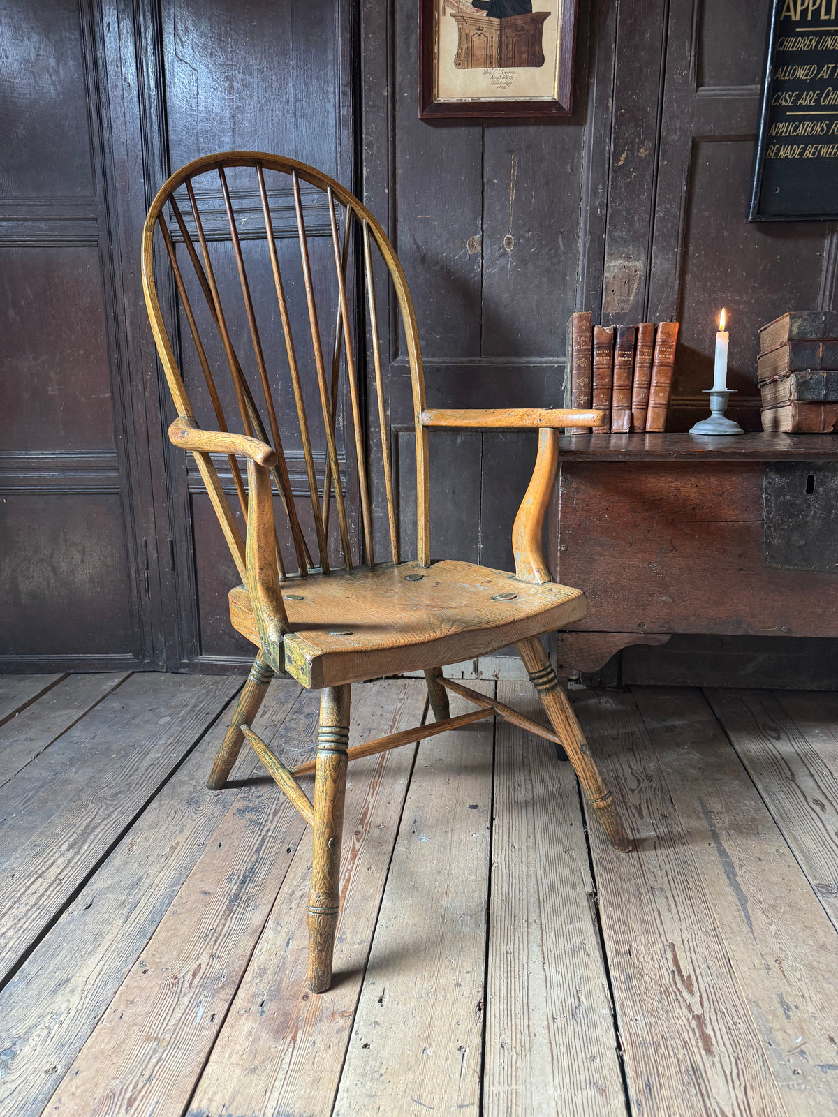 An unusual George III elm and ash high hoop-back Windsor armchair, probably West Country, circa 1800