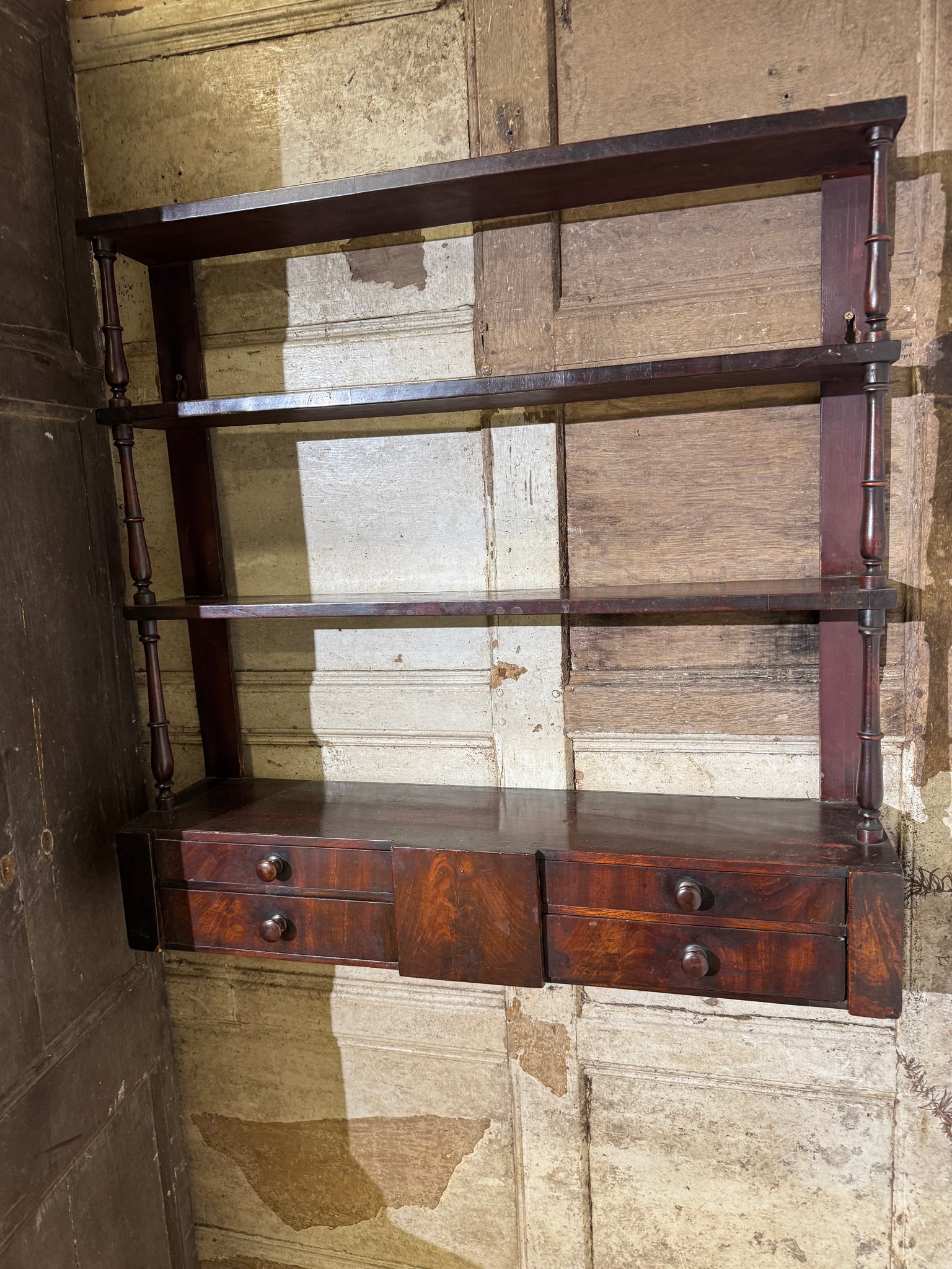 A 19th century set of mahogany apothecary wall shelves with original labels to drawer interiors
