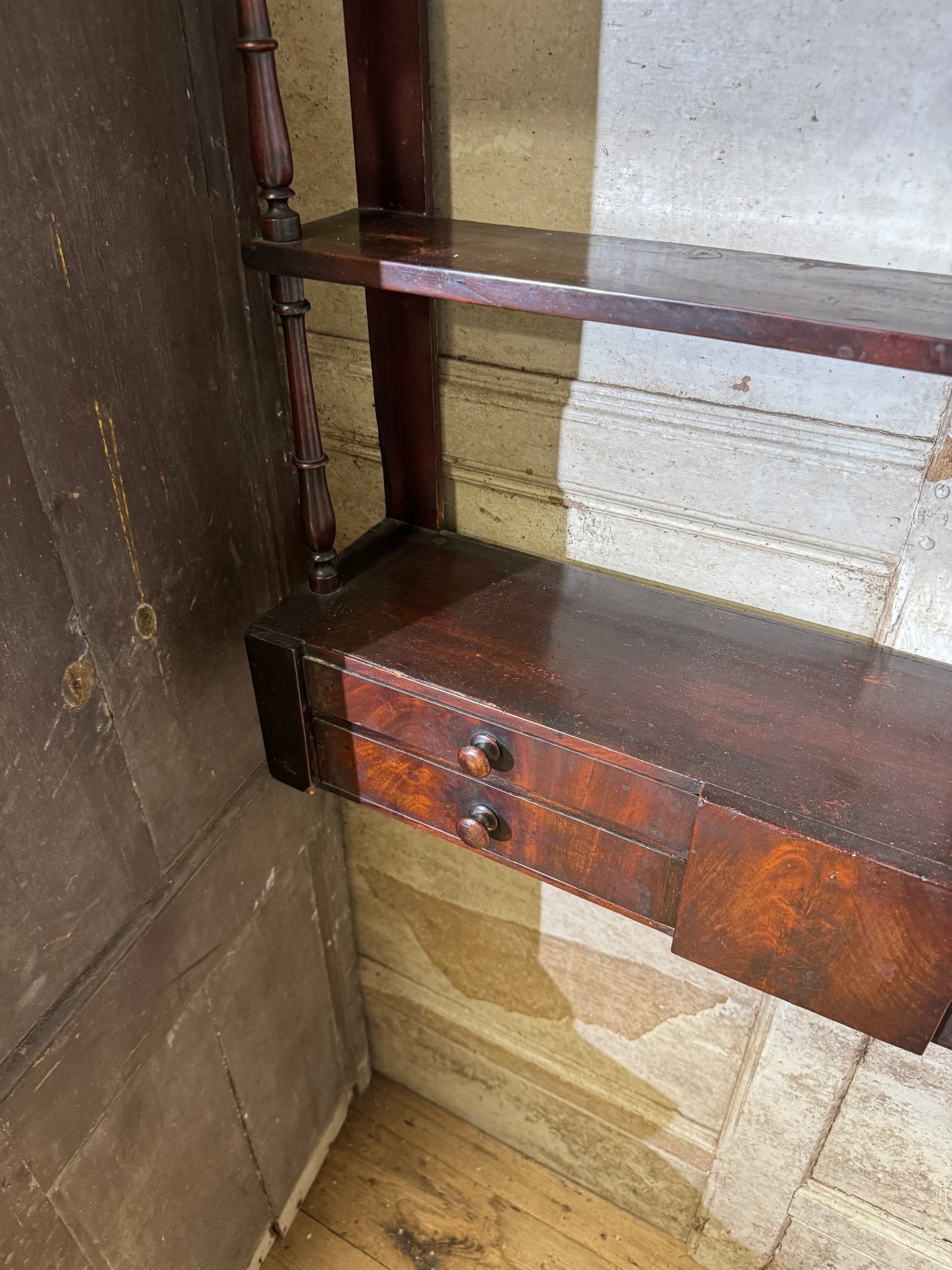 A 19th century set of mahogany apothecary wall shelves with original labels to drawer interiors