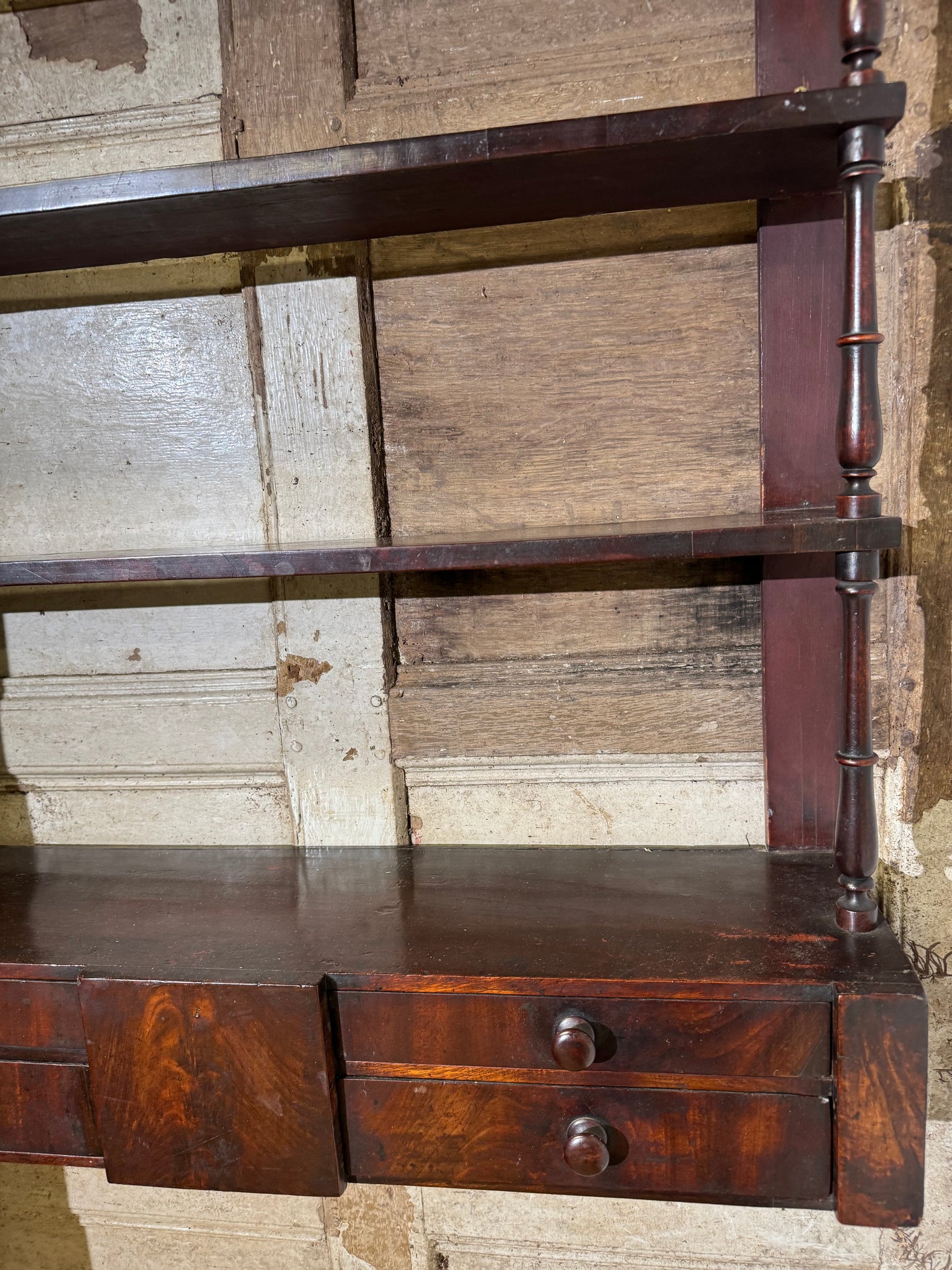 A 19th century set of mahogany apothecary wall shelves with original labels to drawer interiors