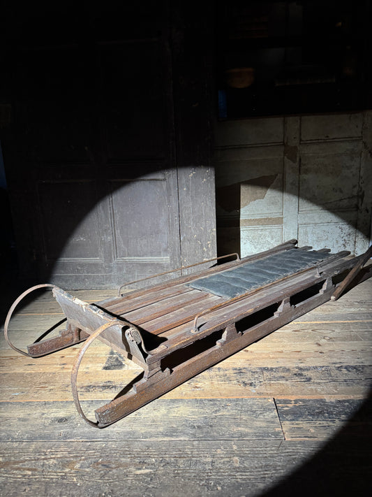Early 20th century wooden toboggan with metal skids and wooden brakes and original seat