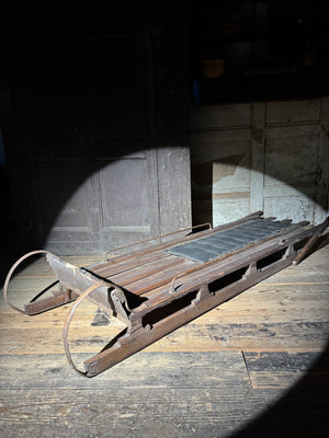 Early 20th century wooden toboggan with metal skids and wooden brakes and original seat