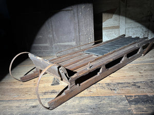 Early 20th century wooden toboggan with metal skids and wooden brakes and original seat