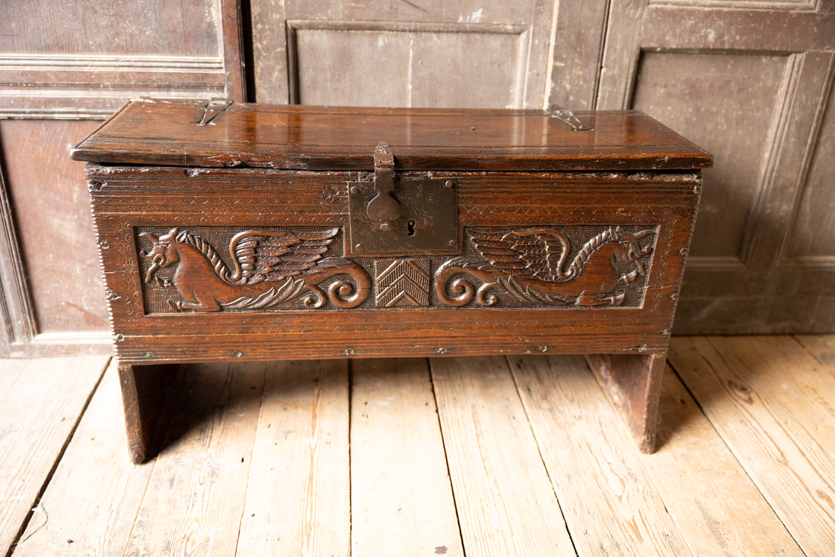 An  Elizabethan carved oak boarded chest with winged fantastic beasts, english, probably West Country, circa 1570–90