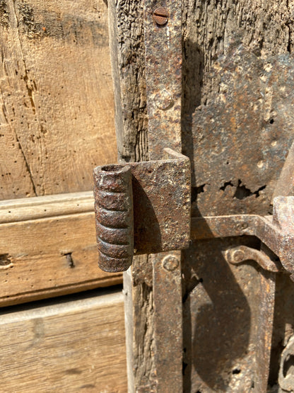 A large sculptural 17th century lock mounted on an oak board