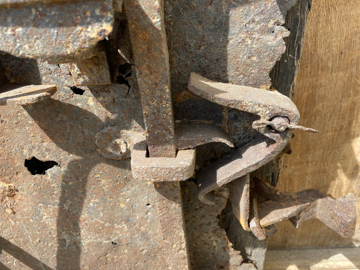 A large sculptural 17th century lock mounted on an oak board