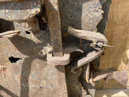 A large sculptural 17th century lock mounted on an oak board