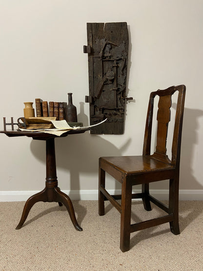 A large sculptural 17th century lock mounted on an oak board