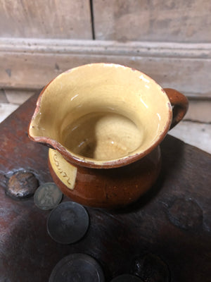 Slipware cream jug by Isaac Button of Halifax