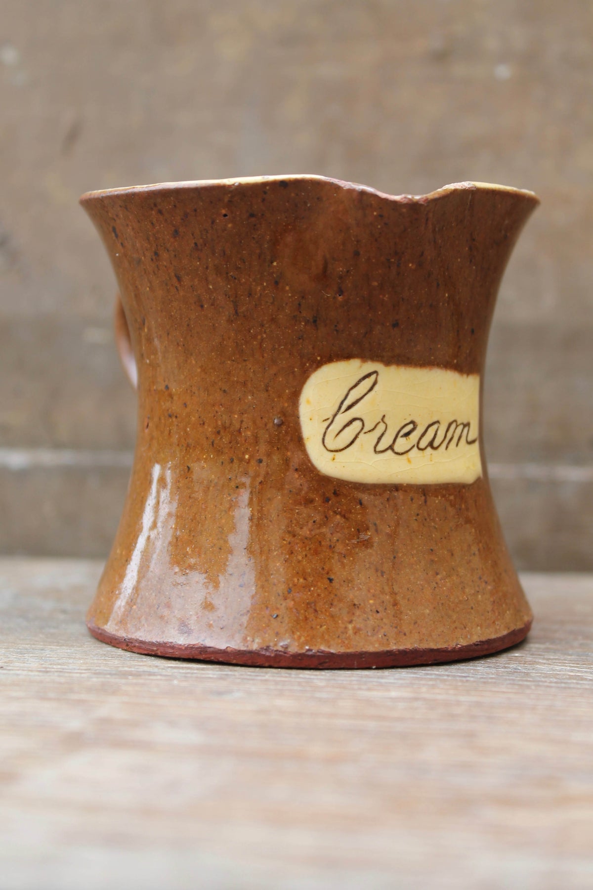 Slipware cream jug by Isaac Button of Halifax