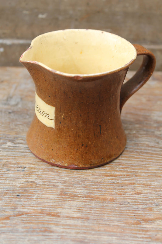 Slipware cream jug by Isaac Button of Halifax