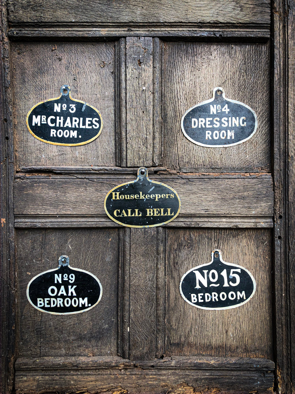 A set of five toleware country house servant's bell signs
