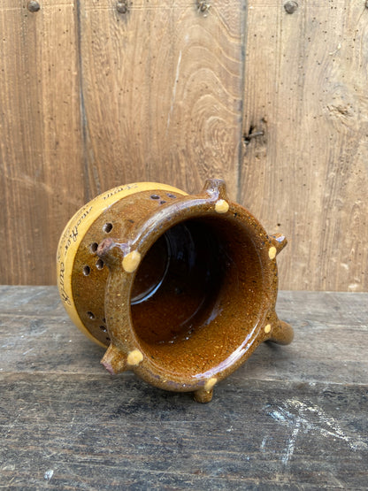 A slipware puzzle jug by Isaac Button of Halifax