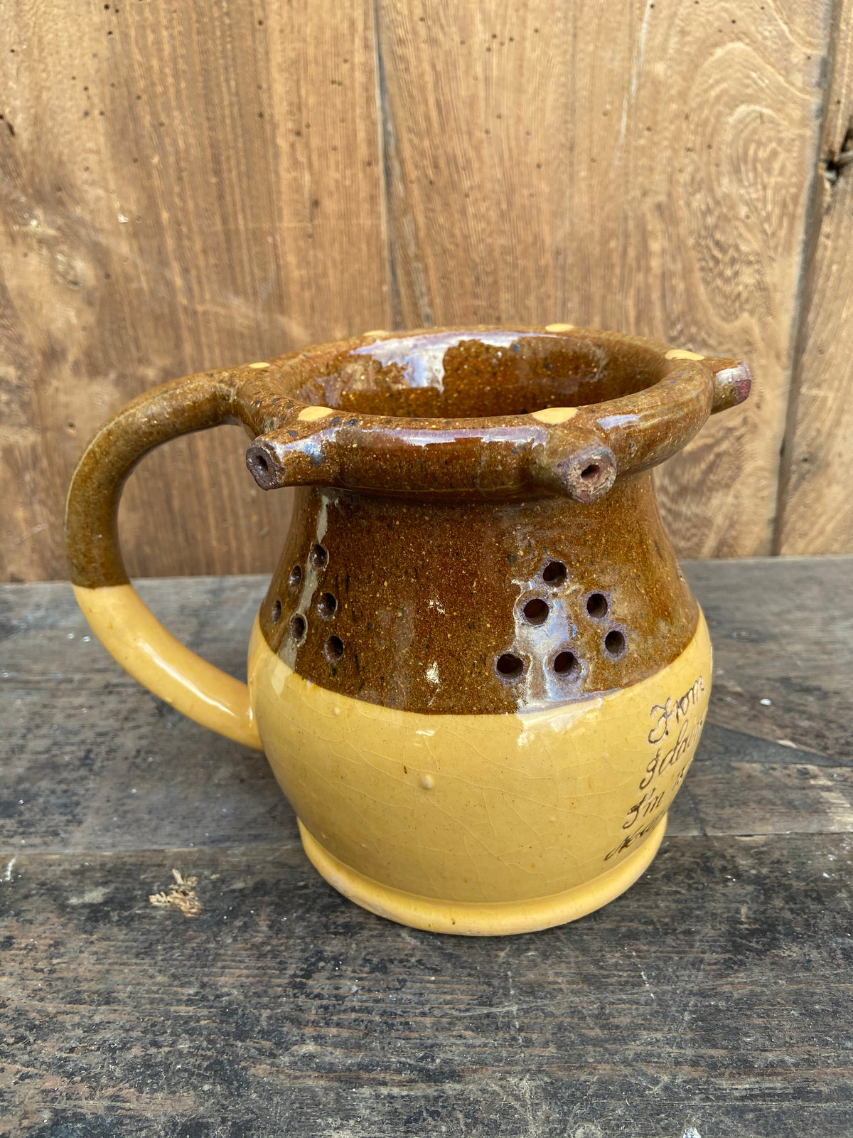 A slipware puzzle jug by Isaac Button of Halifax