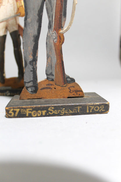 A pair of wooden painted soldiers by Lt E.V Howell c. 1929.