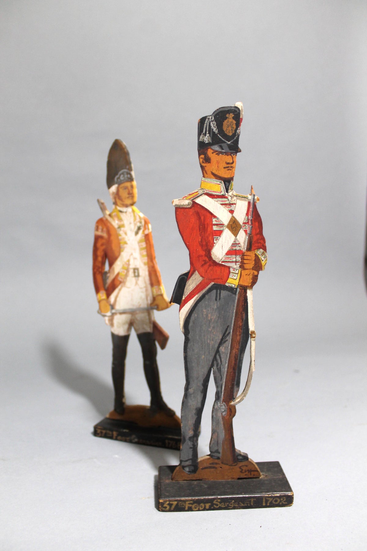 A pair of wooden painted soldiers by Lt E.V Howell c. 1929.