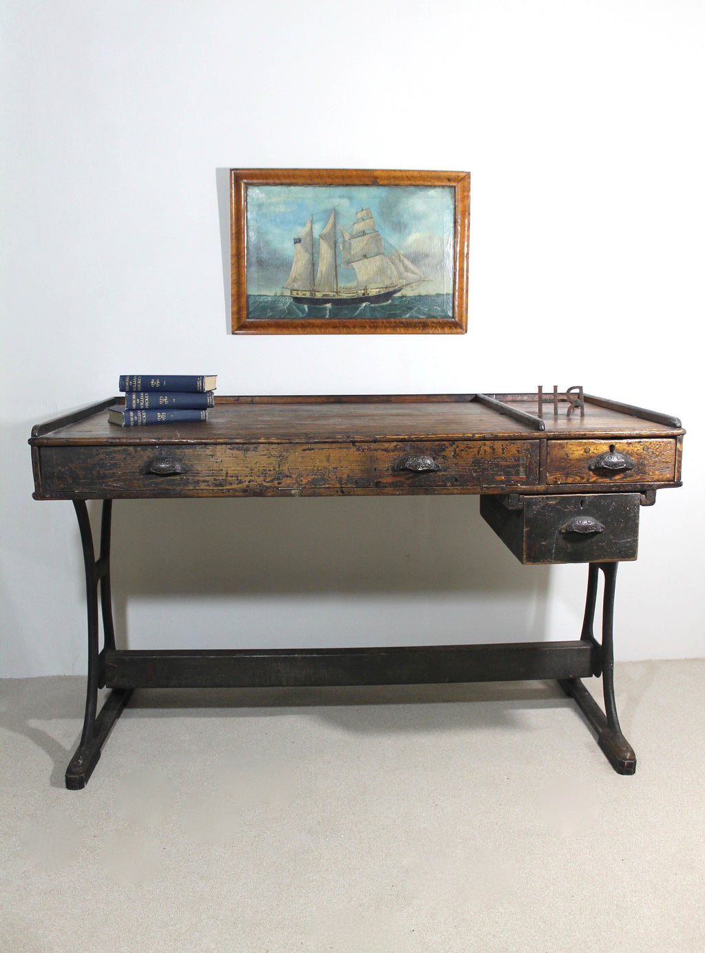 A large 19th century printer's table on a cast iron base