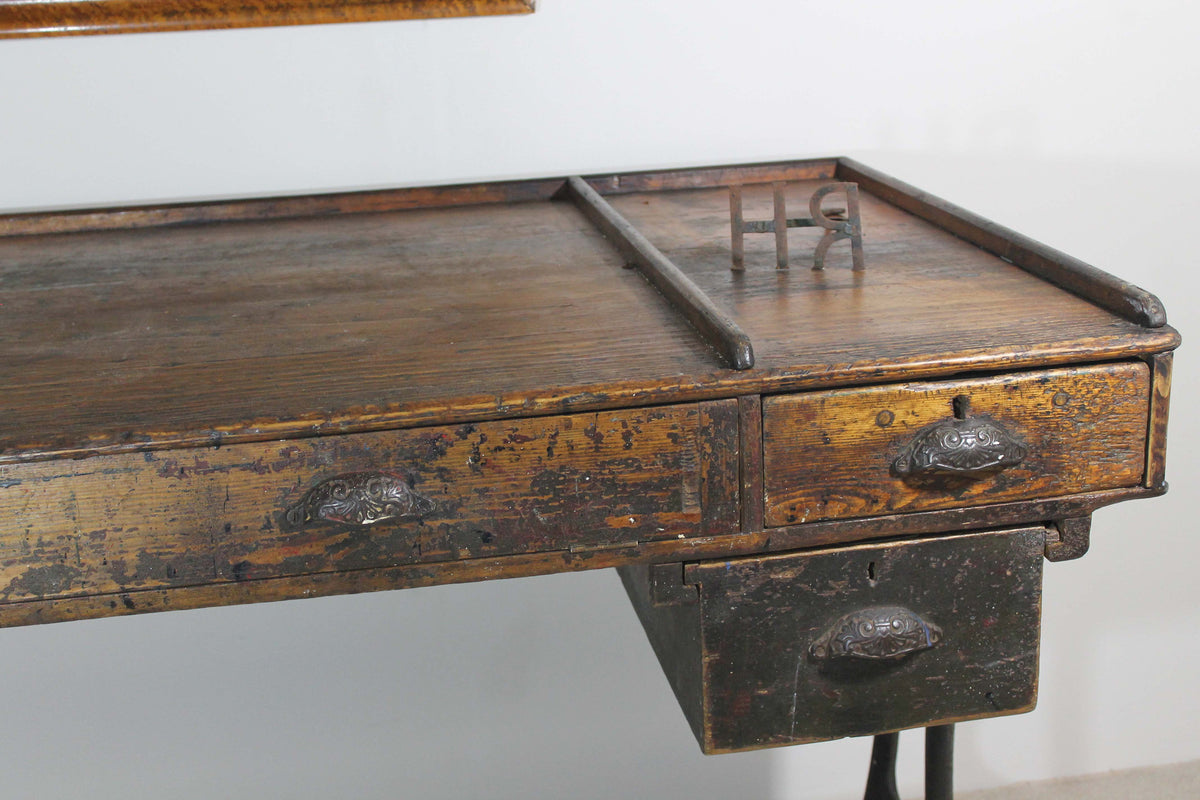 A large 19th century printer's table on a cast iron base