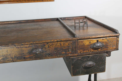 A large 19th century printer's table on a cast iron base