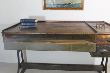 A large 19th century printer's table on a cast iron base