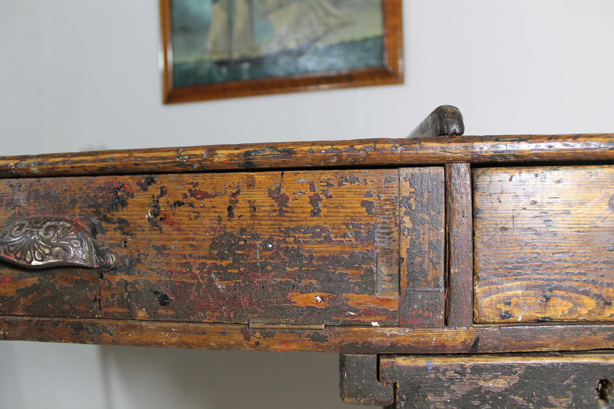A large 19th century printer's table on a cast iron base