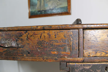 A large 19th century printer's table on a cast iron base