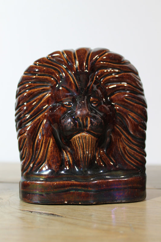 Set of four treacle glazed sash window stops in the form of lions c. 1870