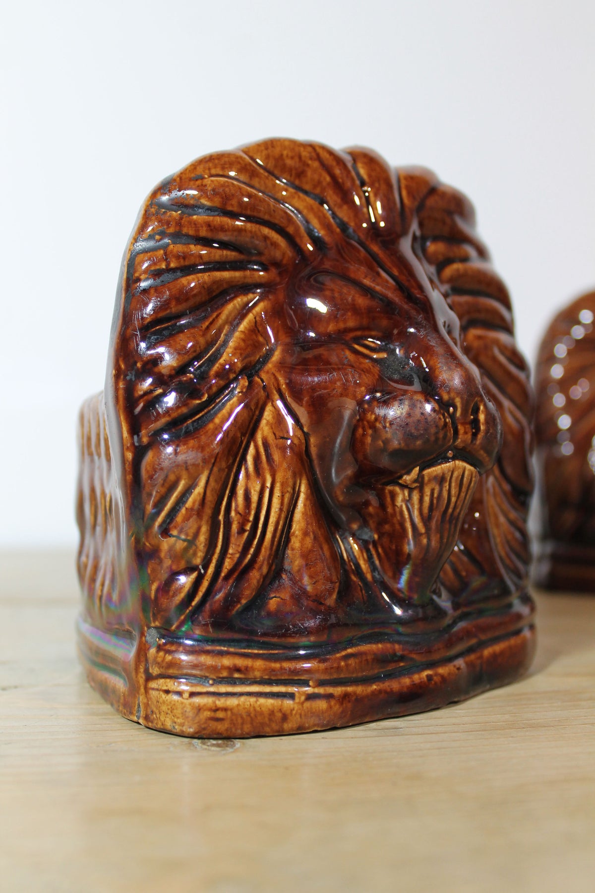 Set of four treacle glazed sash window stops in the form of lions c. 1870