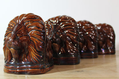 Set of four treacle glazed sash window stops in the form of lions c. 1870