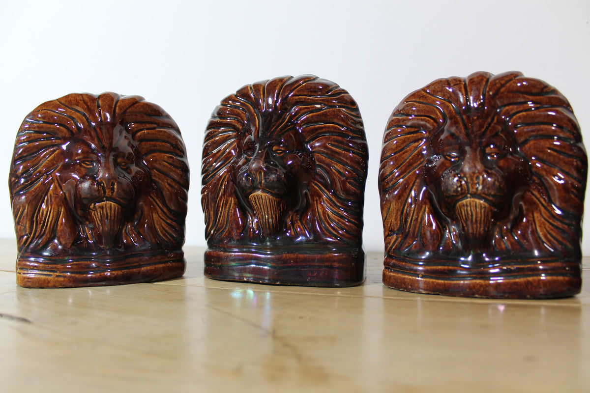 Set of four treacle glazed sash window stops in the form of lions c. 1870