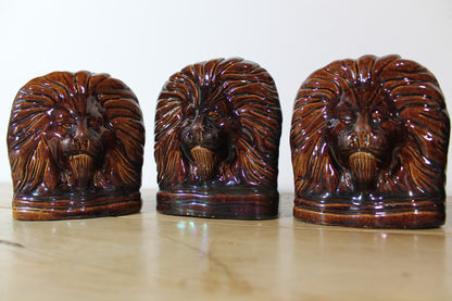 Set of four treacle glazed sash window stops in the form of lions c. 1870
