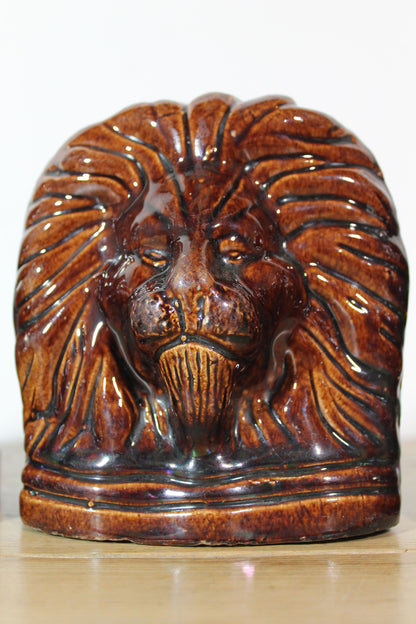 Set of four treacle glazed sash window stops in the form of lions c. 1870