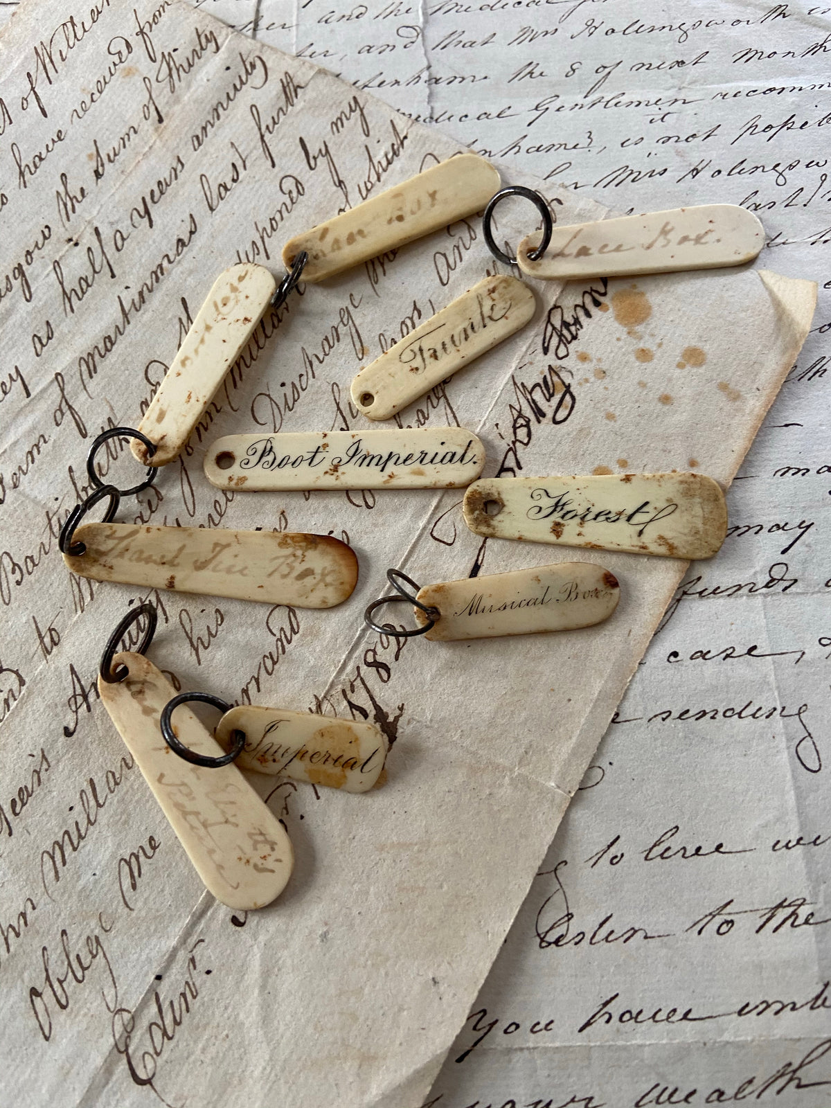 A set of mid 19th century ivory key labels