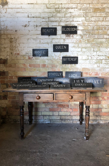 Collection of early 20th century dairy herd name boards from a Flintshire dairy farm