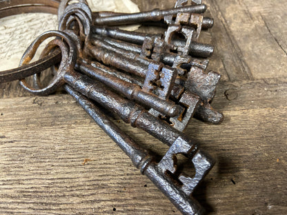 A set of 17th century large iron keys on original iron hoop