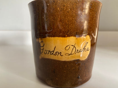 A slipware mug by Isaac Button of Soil Hill, Halifax