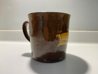 A slipware mug by Isaac Button of Soil Hill, Halifax