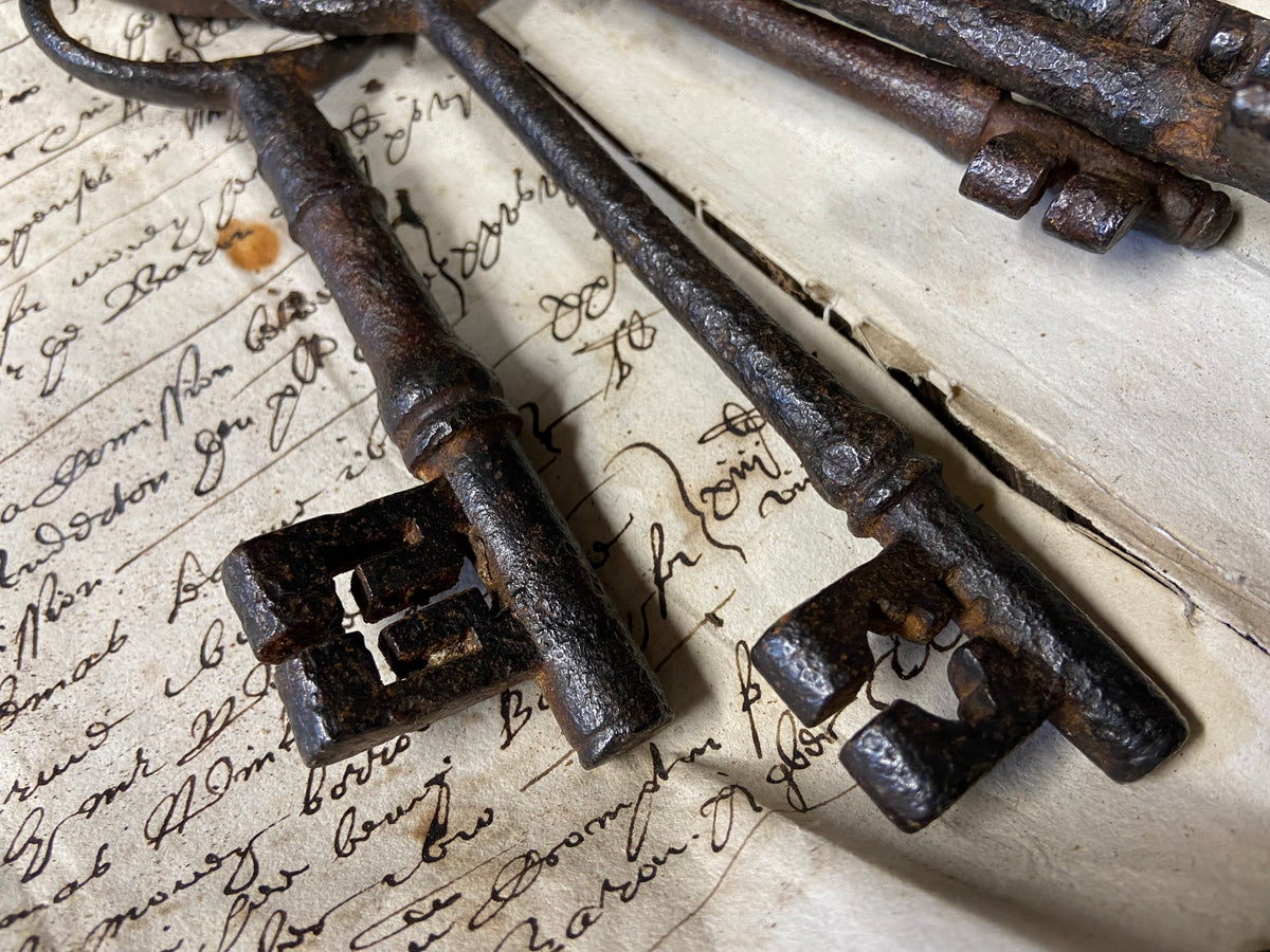 A set of 17th century large iron keys on original iron hoop