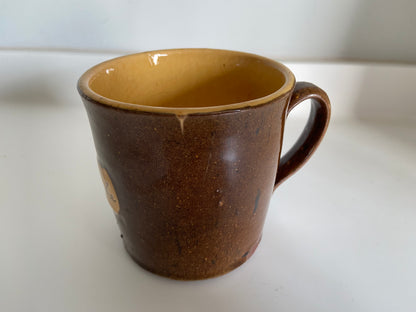 A slipware mug by Isaac Button of Soil Hill, Halifax