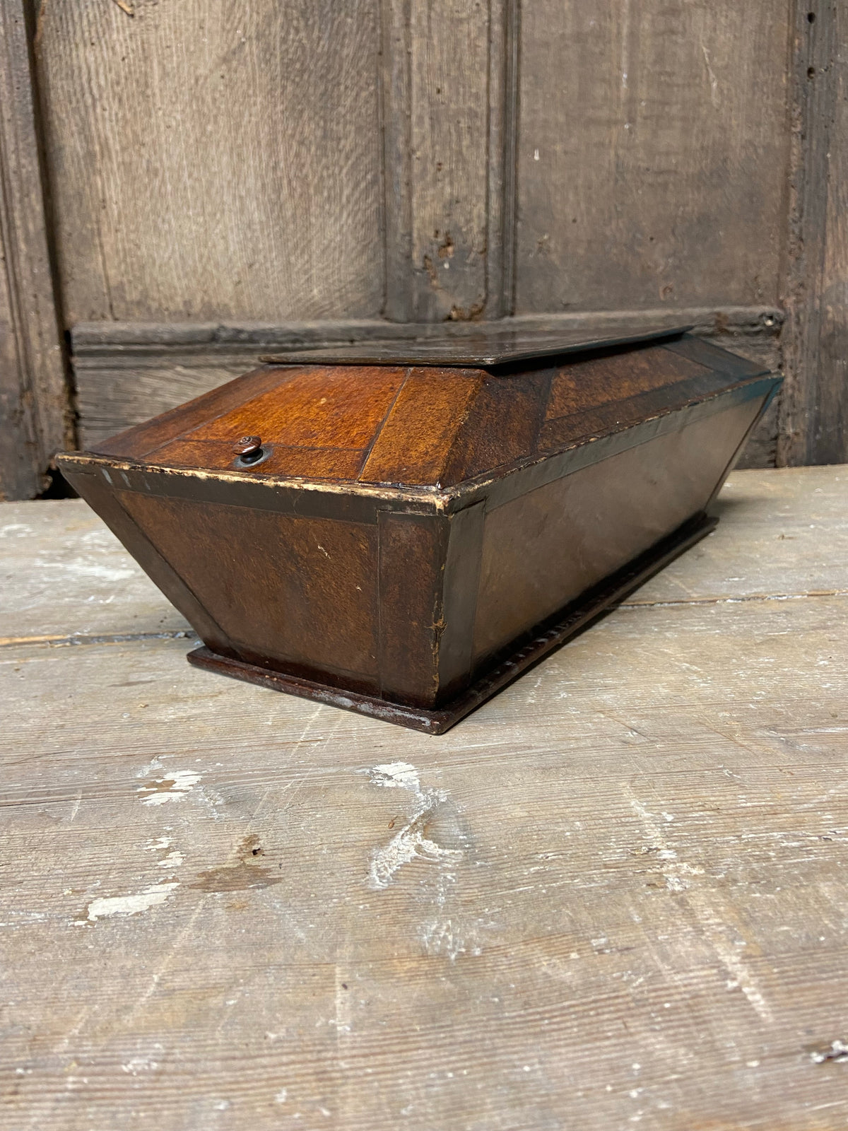 A Regency papier mache candle box in the form of a sarcophagus